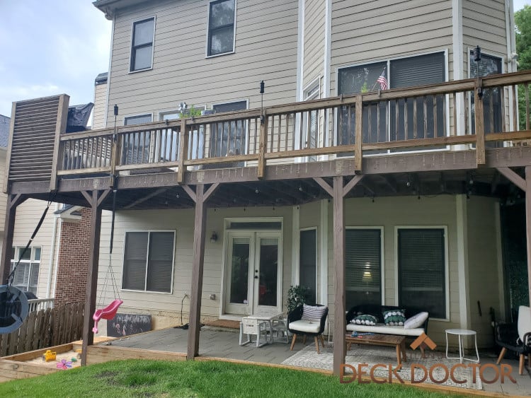 Deck Refinishing Project In Decatur, Georgia. Before Picture. Posts Were Painted, We sanded Those To The bare Wood, Then Stained With An Amber stain From TWP