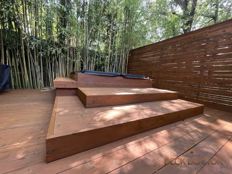 Hot Tub Deck Staining & Sealing Cedar Hot Tub Deck With Cedar Privacy Screening. Bamboo In Background Creating A cozy Environment.
