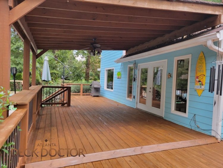 Light Blue Beachy Toned Siding With Dark Brown Stain & Sealer.